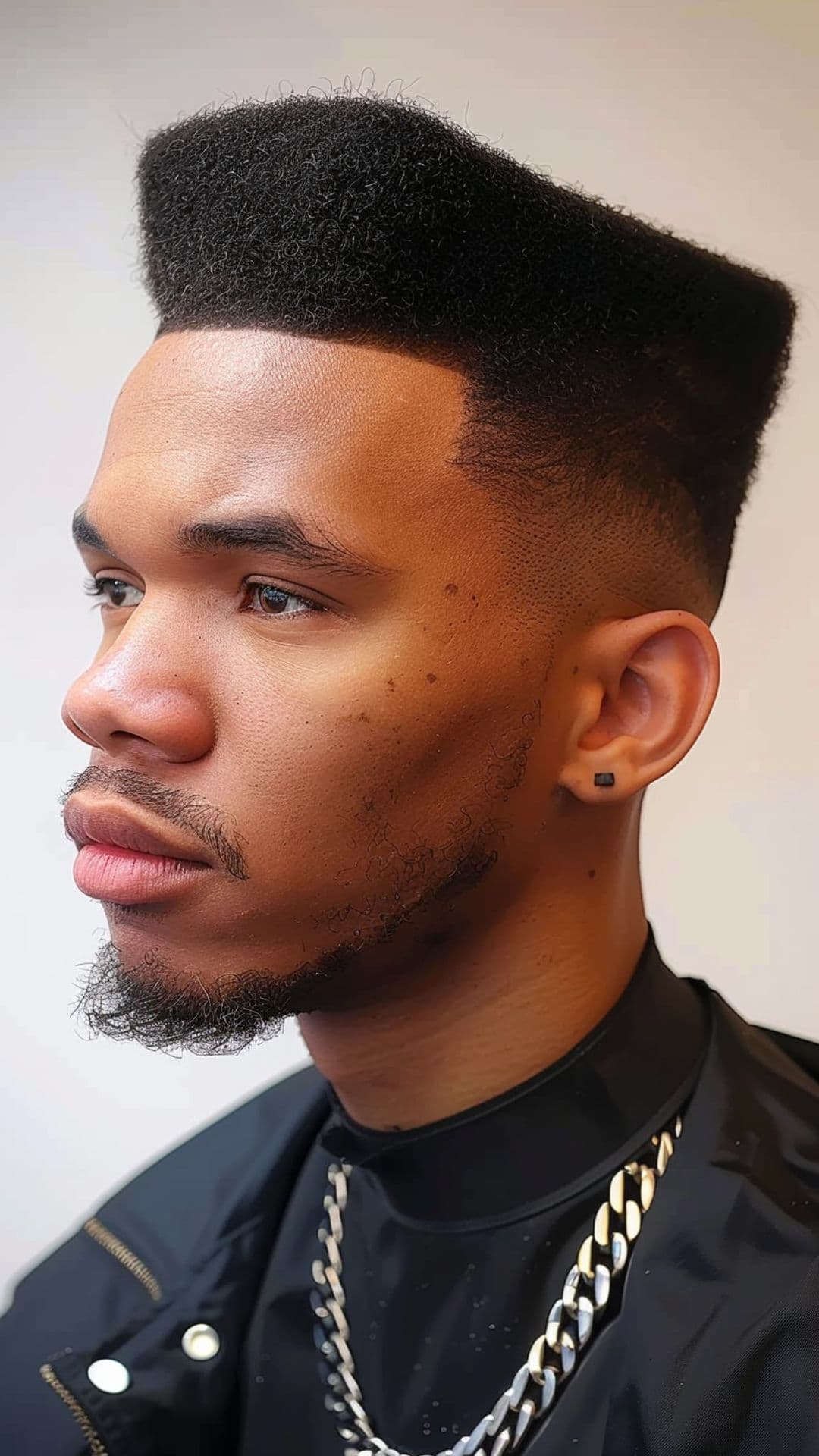 A black man wearing a flat top hairstyle.