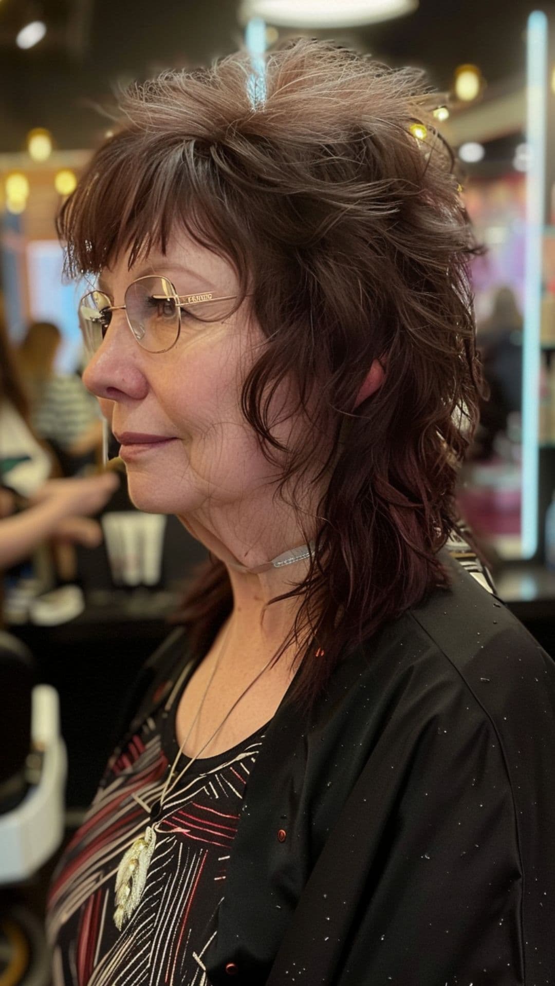 An old woman shaping shaggy bangs.