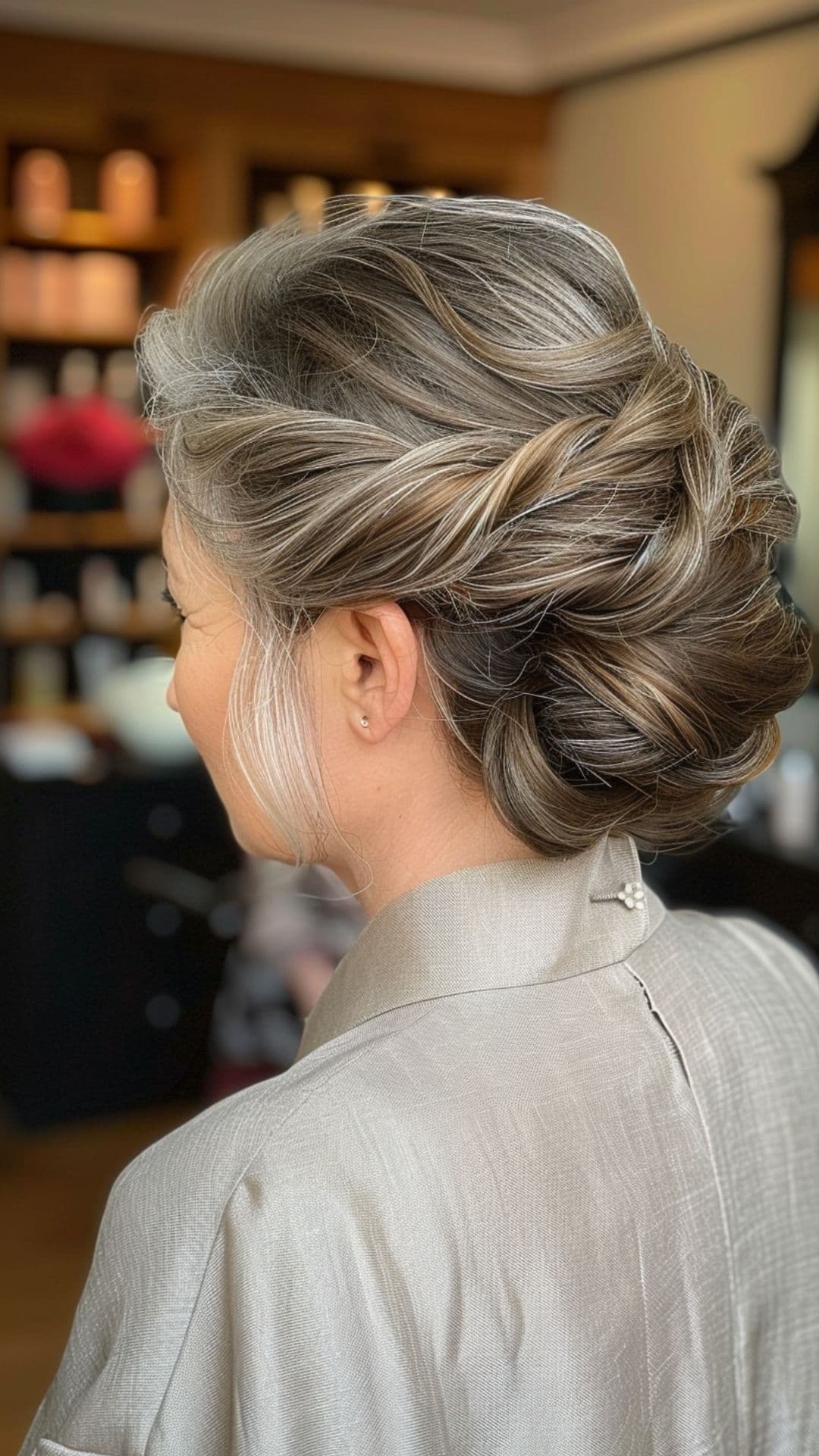 An old woman wearing a braided bun hairstyle.